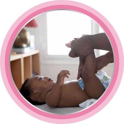 Putting on a diaper after applying nappy cream.